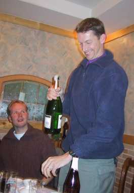 Jos opens up the Champagne bottle to celebrate the success of the Sino-Dutch Leonid Expedition 2001
